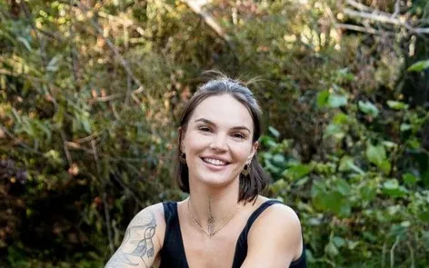 Jaqulynn Schultz, who guides The Belly Workshop, seated outdoors
